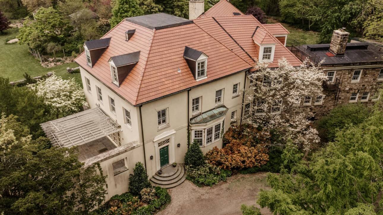 aerial shot of a big house surrounded by trees