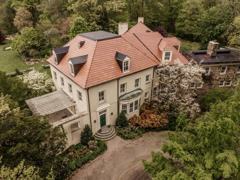 aerial shot of a big house surrounded by trees