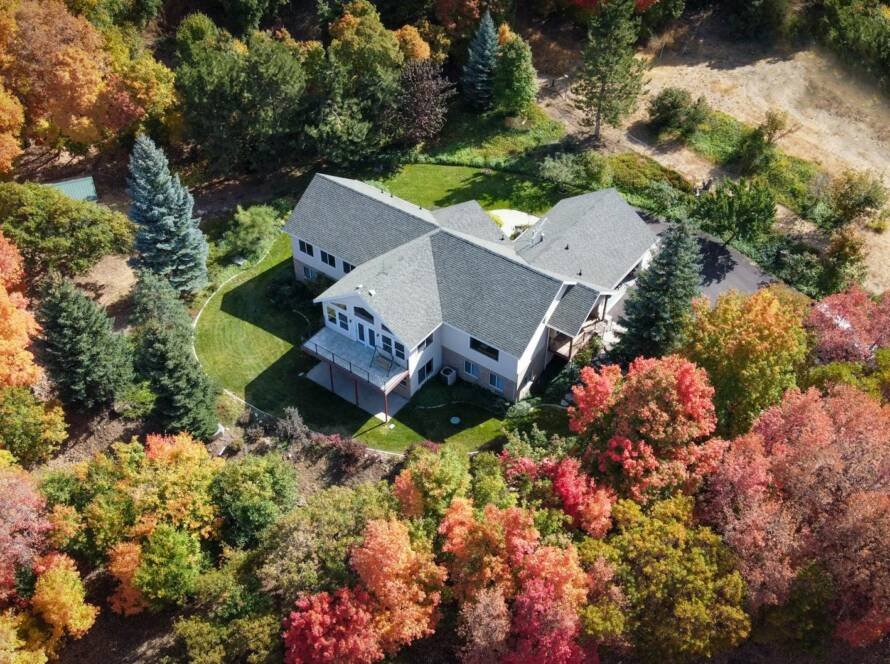 an aerial shot of a house surrounded by trees