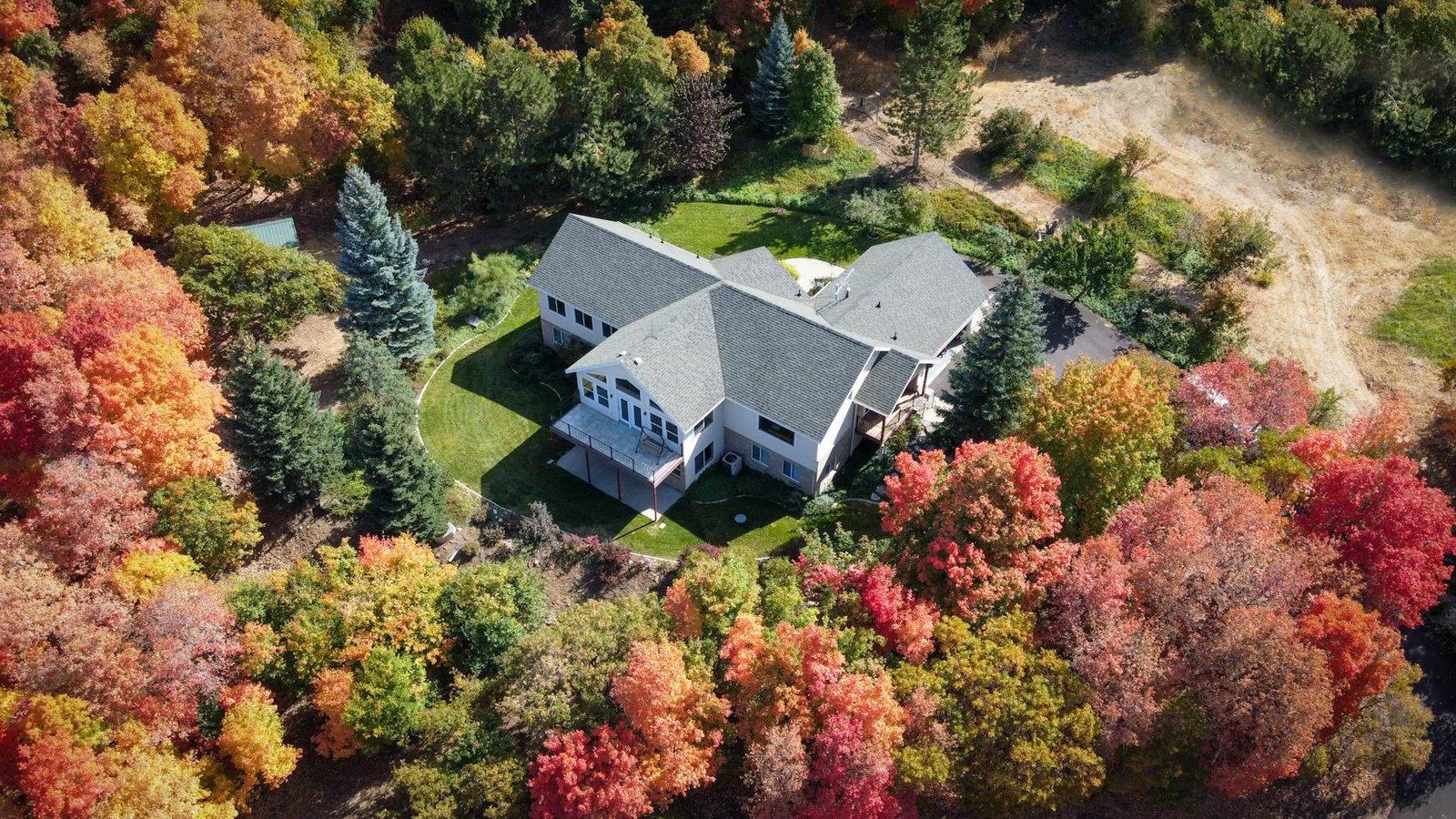 an aerial shot of a house surrounded by trees